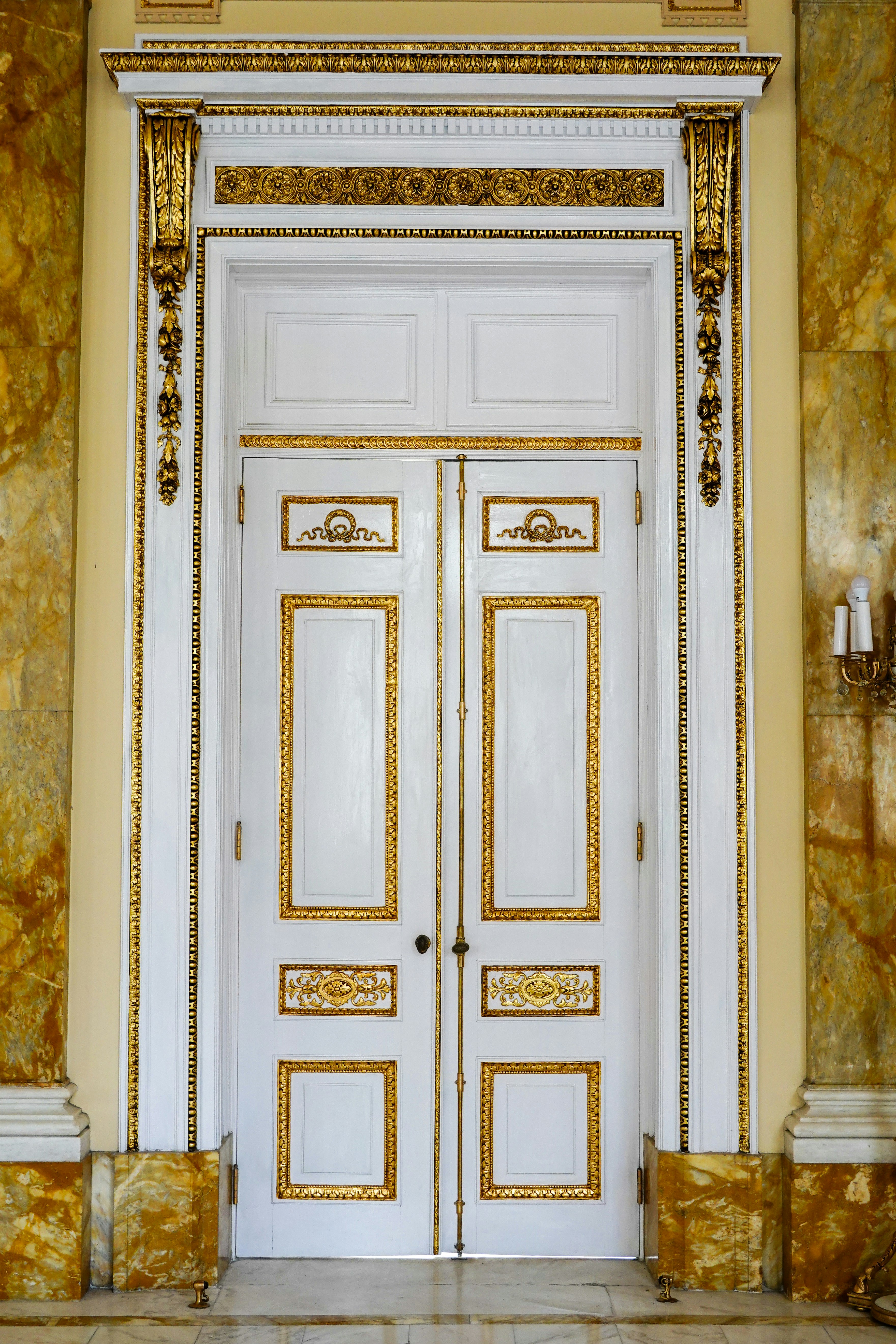 white wooden door beside white wall